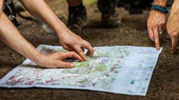 a group of people pointing at a map
