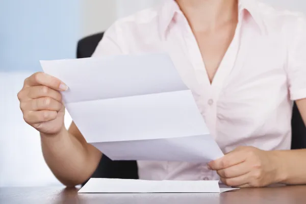 a woman holding a piece of paper