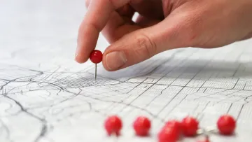 a hand holding a red ball