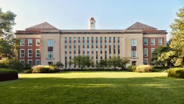 a large building with a lawn in front of it