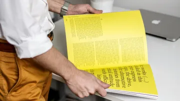 a man holding a yellow box