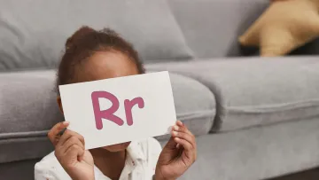a child holding a sign
